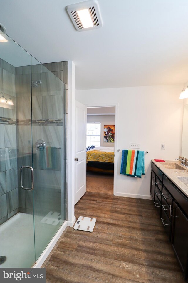 bathroom with vanity, hardwood / wood-style floors, and walk in shower