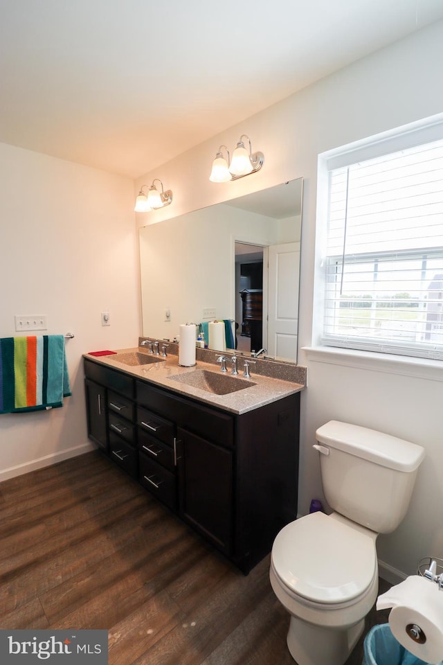 bathroom featuring vanity, toilet, and hardwood / wood-style flooring