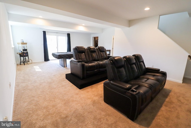 cinema room featuring light carpet