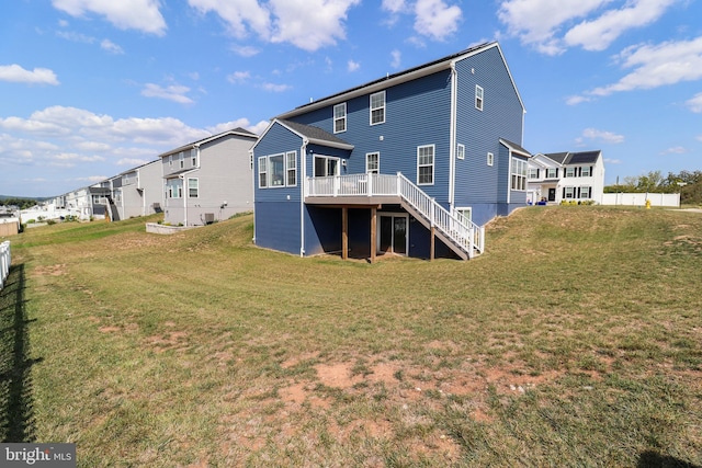 back of house featuring a wooden deck, a yard, and central AC