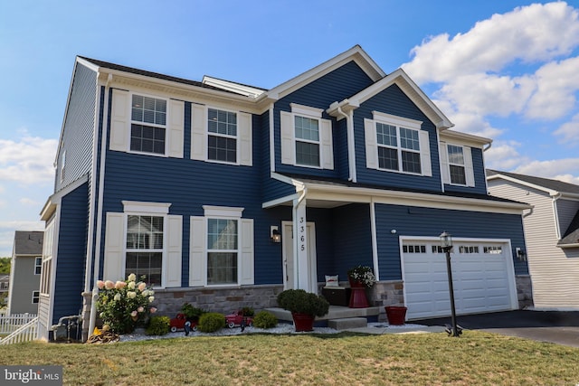 view of front of house with a garage and a front yard