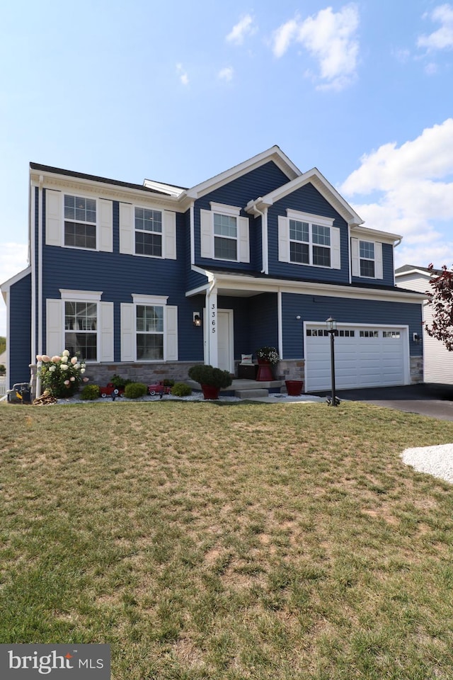 view of front of property with a garage and a front yard