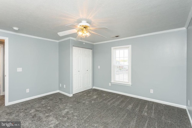 unfurnished room with ceiling fan, carpet, crown molding, and a textured ceiling