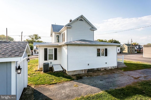 rear view of property with central air condition unit