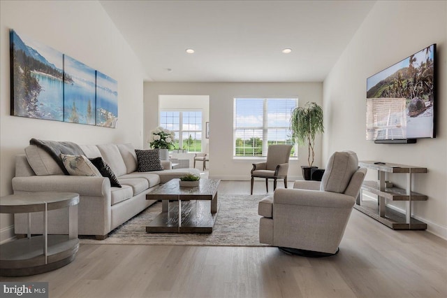 living room with recessed lighting, wood finished floors, and baseboards