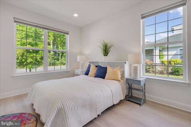 bedroom featuring recessed lighting, multiple windows, wood finished floors, and baseboards