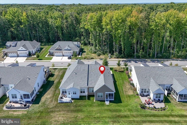 birds eye view of property featuring a residential view and a view of trees