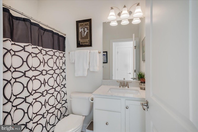 bathroom featuring curtained shower, toilet, and vanity