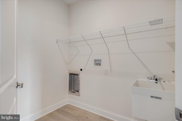 washroom with light wood finished floors, baseboards, laundry area, hookup for a washing machine, and hookup for an electric dryer