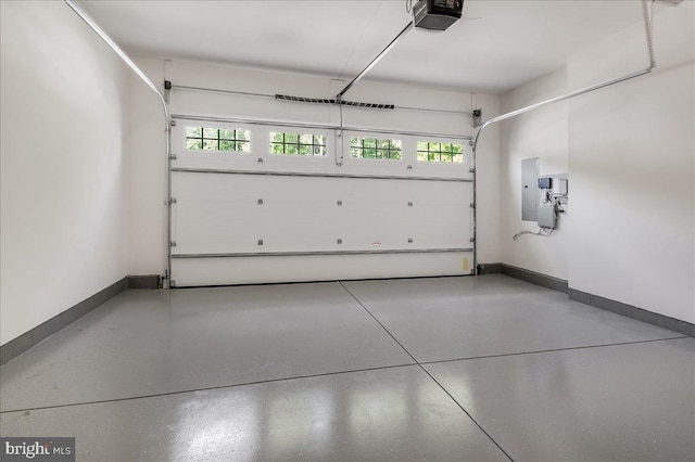 garage featuring a garage door opener and baseboards