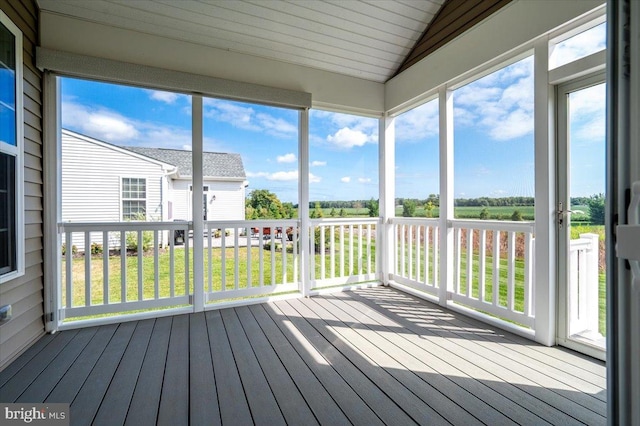 unfurnished sunroom with lofted ceiling