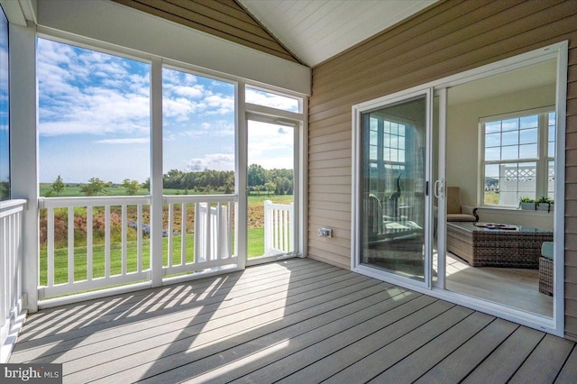 unfurnished sunroom featuring a wealth of natural light and lofted ceiling