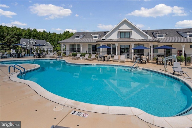 view of pool with fence and a patio area