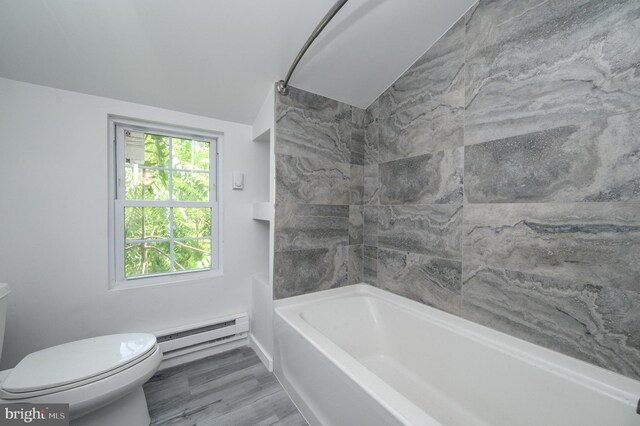 full bathroom featuring a baseboard heating unit, vaulted ceiling, toilet, and hardwood / wood-style floors