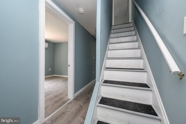 stairs with wood-type flooring