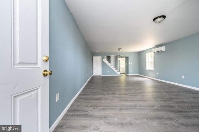 empty room with hardwood / wood-style flooring and a wall mounted air conditioner