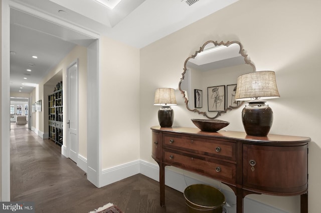 corridor featuring dark parquet flooring