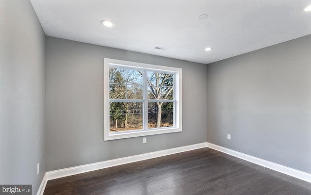 unfurnished room featuring dark hardwood / wood-style flooring