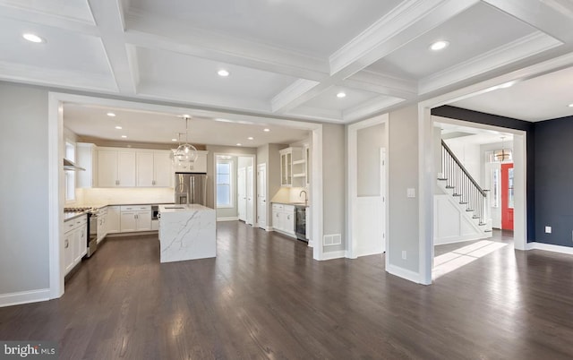 kitchen featuring pendant lighting, white cabinetry, a kitchen island, stainless steel appliances, and dark hardwood / wood-style flooring