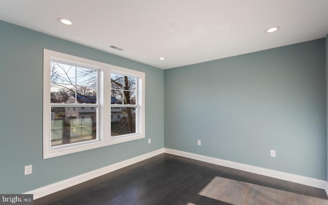 unfurnished room featuring dark wood-type flooring