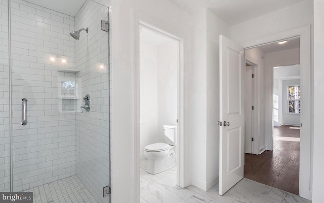 bathroom featuring walk in shower, hardwood / wood-style flooring, and toilet