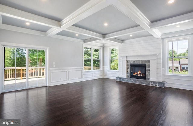 unfurnished living room with a healthy amount of sunlight, a fireplace, and dark hardwood / wood-style flooring