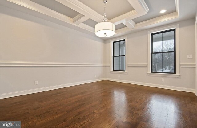 empty room with beam ceiling, coffered ceiling, crown molding, and dark hardwood / wood-style flooring