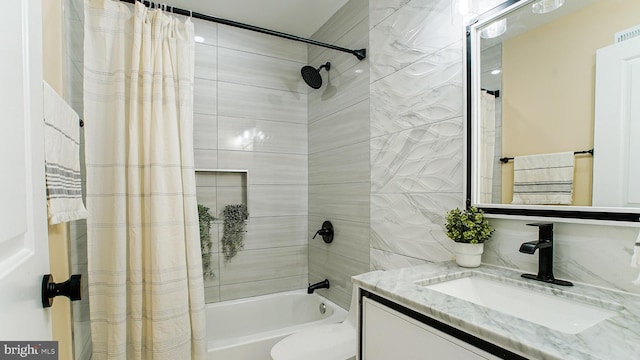 full bathroom with vanity, shower / bath combo with shower curtain, and toilet