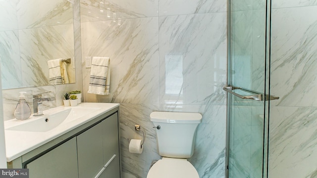 bathroom with vanity, toilet, walk in shower, and tile walls