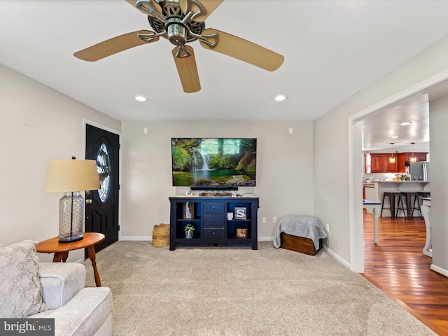 living room featuring ceiling fan and wood-type flooring