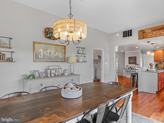 dining room featuring a chandelier and light hardwood / wood-style floors