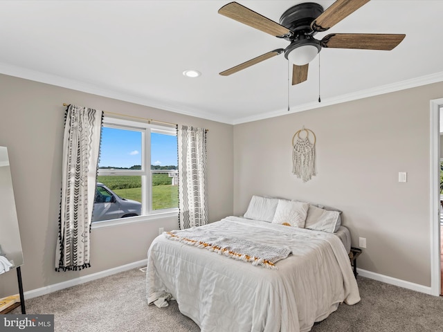 carpeted bedroom featuring crown molding and ceiling fan