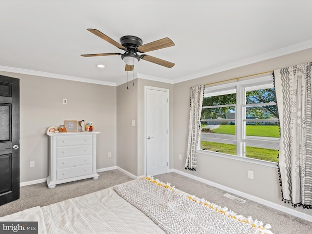 bedroom featuring ceiling fan, ornamental molding, and light carpet