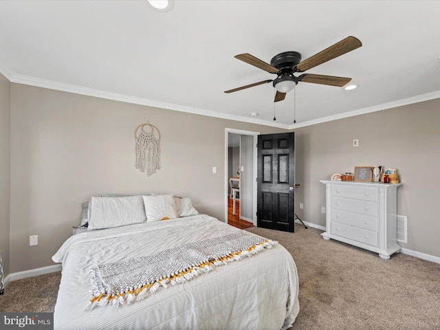 bedroom with ornamental molding, ceiling fan, and carpet flooring