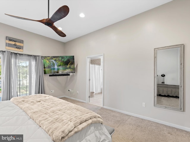 carpeted bedroom with ceiling fan, ensuite bath, and vaulted ceiling