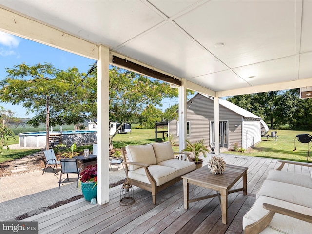 wooden deck with a lawn, an outdoor living space, and an outdoor structure