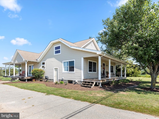 view of front of home with covered porch and a front yard