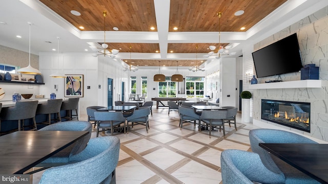 living room with a notable chandelier, a stone fireplace, wooden ceiling, and pool table