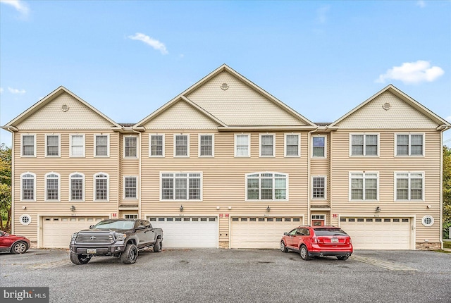 townhome / multi-family property with driveway and an attached garage