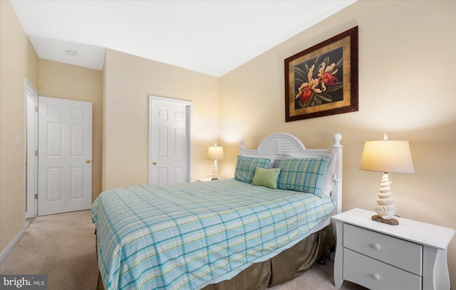 bedroom featuring baseboards and light colored carpet