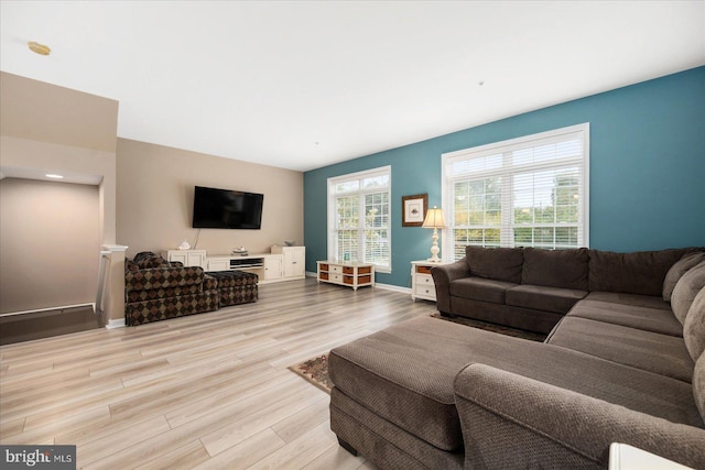 living area featuring baseboards and wood finished floors