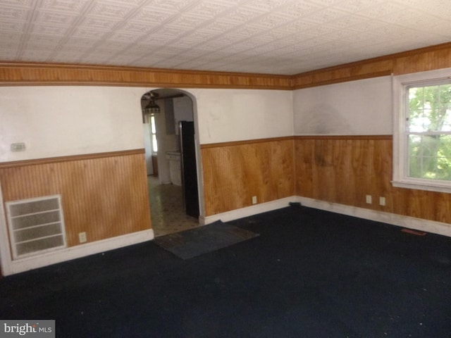 spare room featuring wooden walls