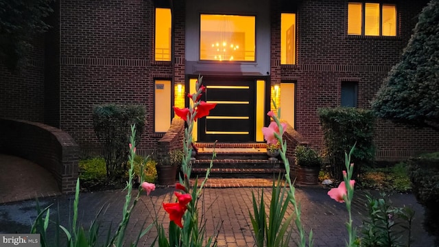 doorway to property featuring brick siding