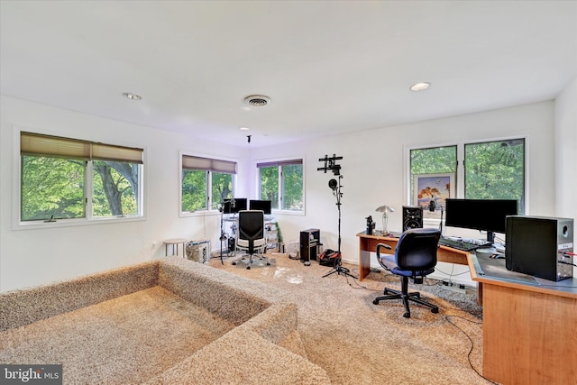 carpeted home office featuring plenty of natural light, recessed lighting, and visible vents