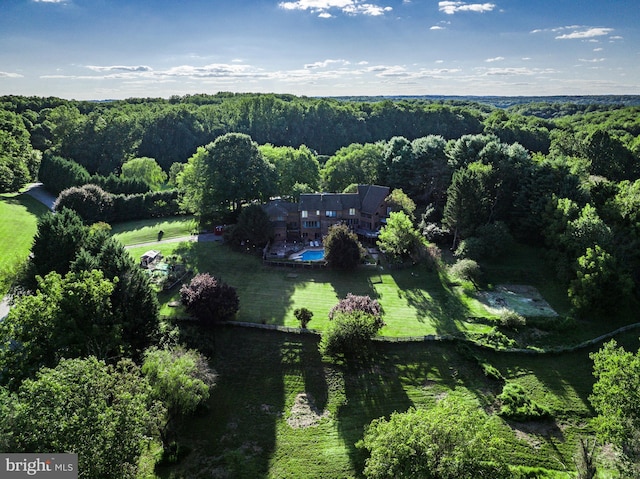 birds eye view of property with a forest view