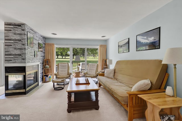 living room with light colored carpet and a stone fireplace