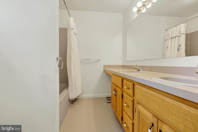 bathroom with vanity, shower / bath combo with shower curtain, and tile patterned floors