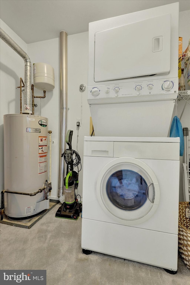 clothes washing area featuring gas water heater, light carpet, and stacked washer / drying machine