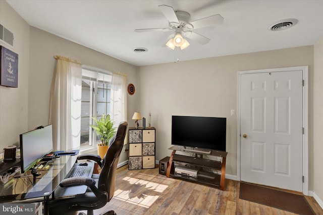 home office featuring light hardwood / wood-style flooring and ceiling fan