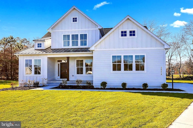 modern farmhouse style home with a front yard